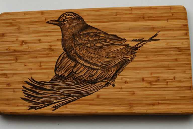 Bird and nest pattern burnt on bamboo cutting board