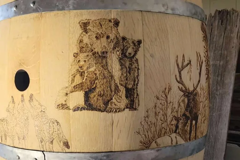 Pyrography of a bear family on wooden barrel