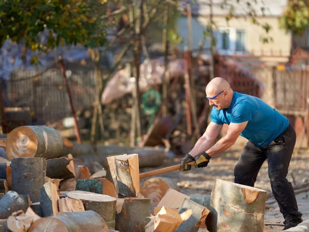 This man using proper safety gear while splitting wood